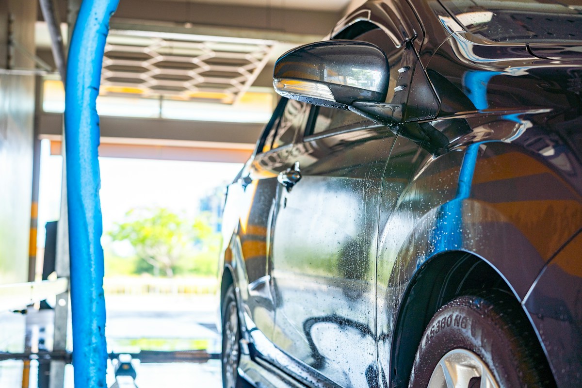 A car being rinsed in the wash bay
